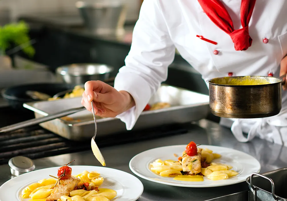 Senior corporate chef and client testing recipes and defining cooking procedures