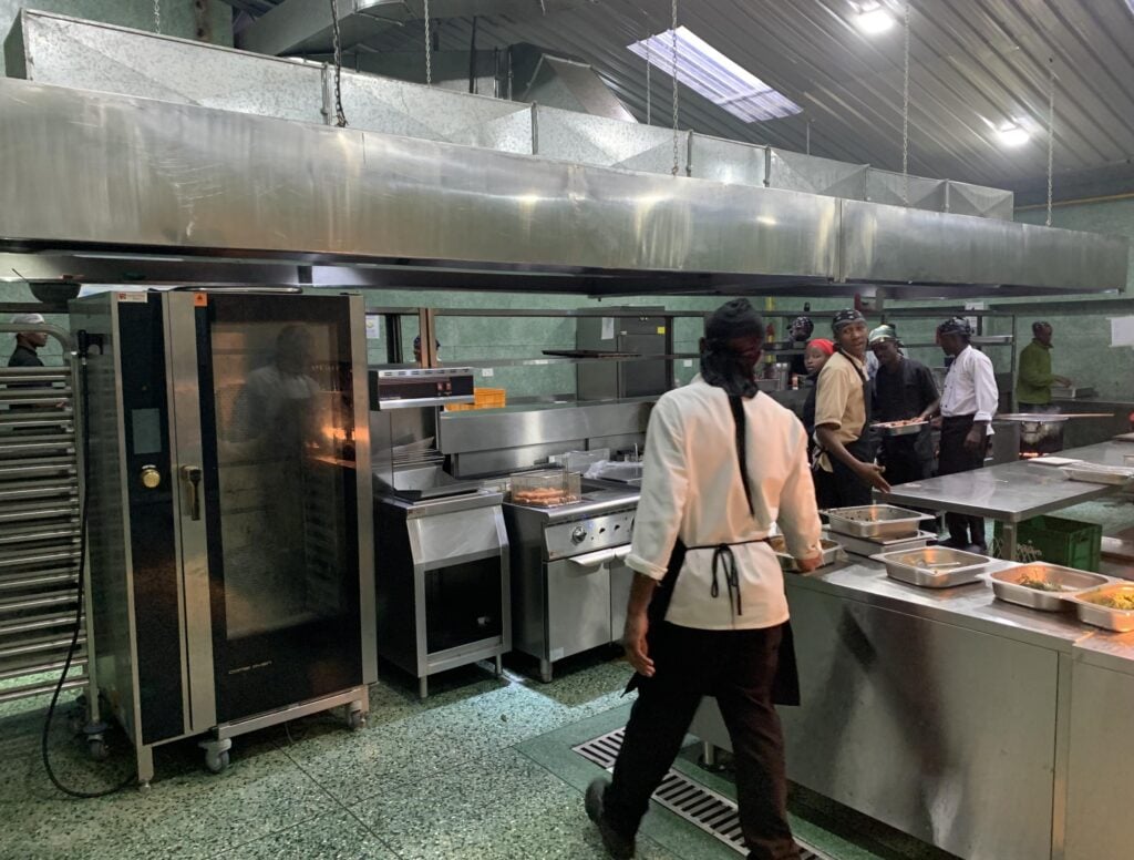 Kitchen team working beside the combi oven and cooking line at Ridge Cabin Resort in Kenya